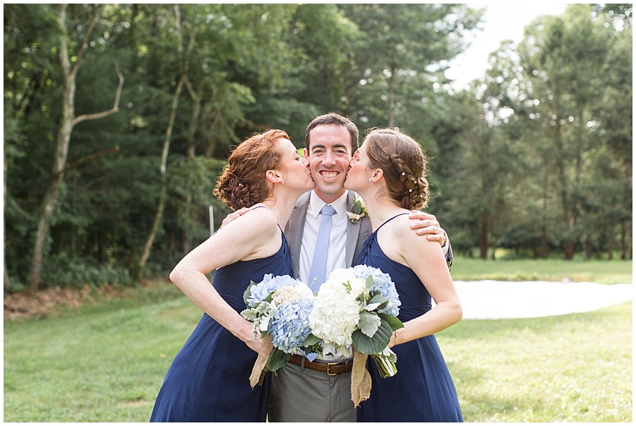 Sisters kiss their brother who is getting married 