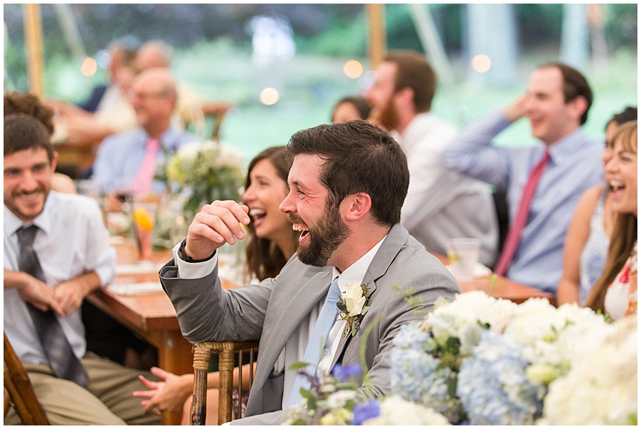 brother laughs during the wedding toasts