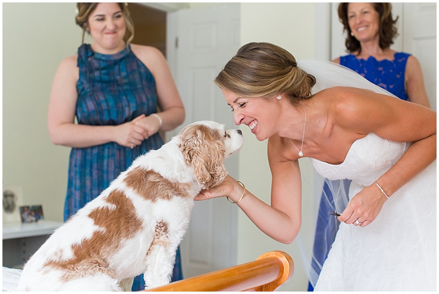 Bride and puppy share a little kiss before wedding 