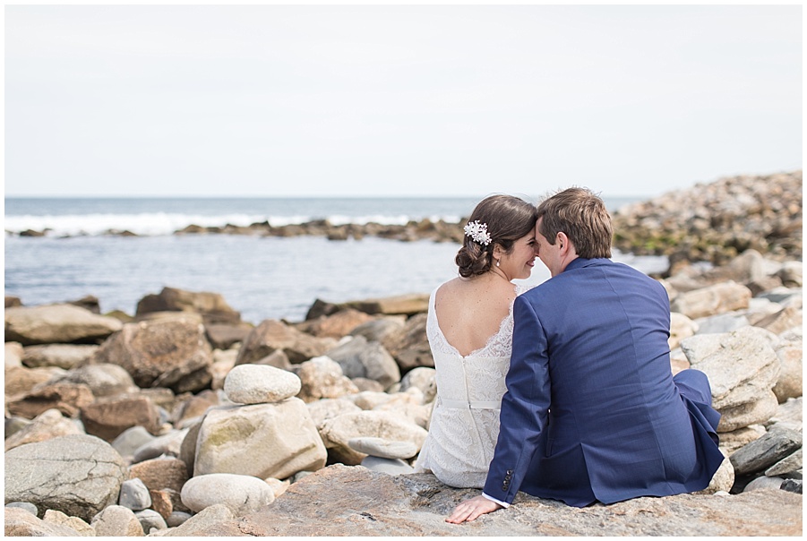 Bride and groom portraits on rocks at Narragansett beach