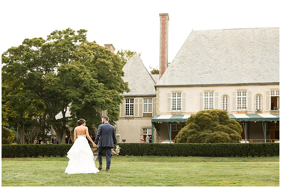 Bride and Groom walking up the lawn at Glen Manor 