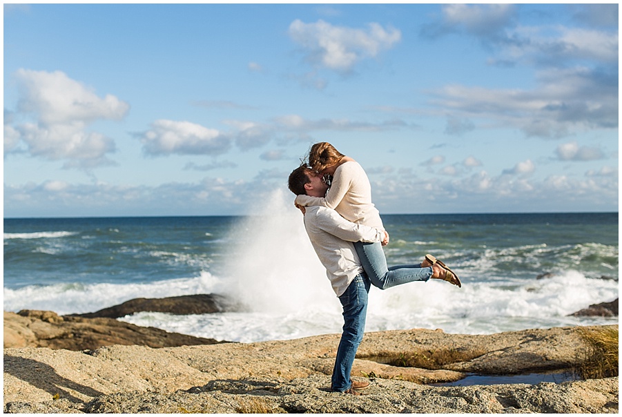 Ocean Drive waves crashing behind engaged couple 
