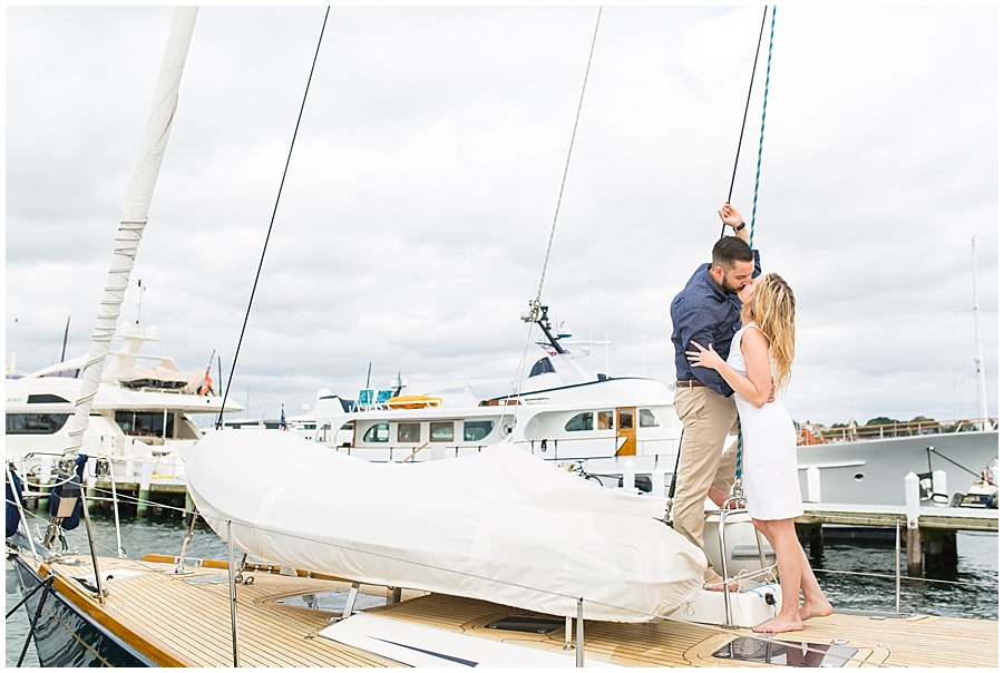 couple kisses on yacht in Newport 