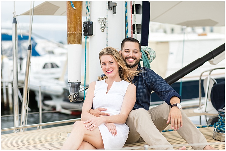 couple poses on yacht in Newport 