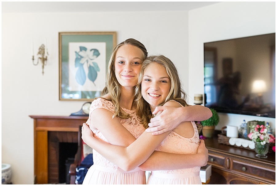 bridesmaids and nieces hug while getting ready 