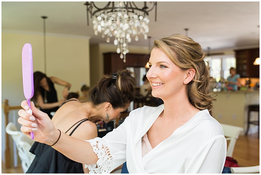 bride getting her hair and makeup done
