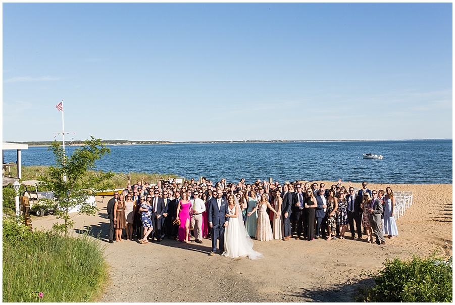 wedding guests surround the bride and groom at cape cod wedding 
