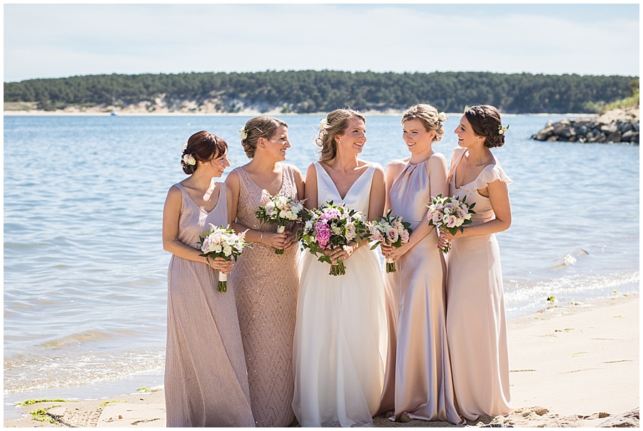 bridesmaids in dusty rose dresses on beach