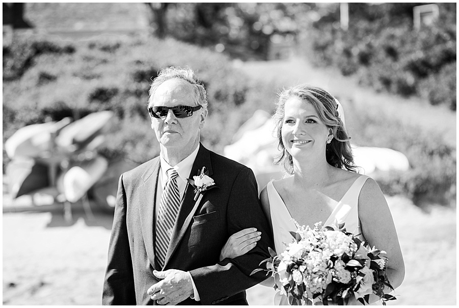 bride and father walk down the aisle at chequesset yacht club