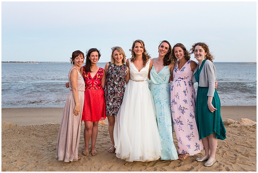 bride and girlfriends on the beach at sunset