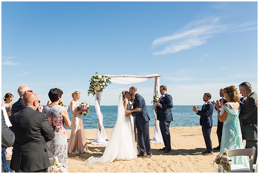 bride and groom's first kiss at cape cod wedding