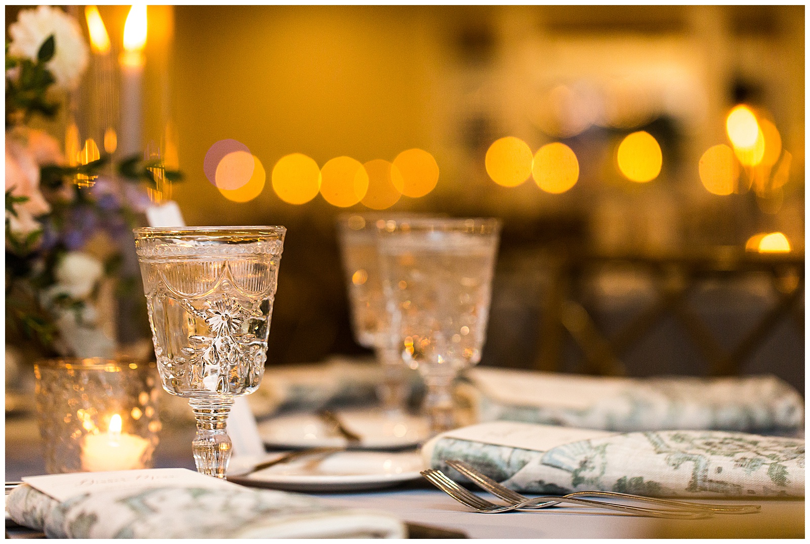 Twinkle lights and delicate glassware at wedding reception