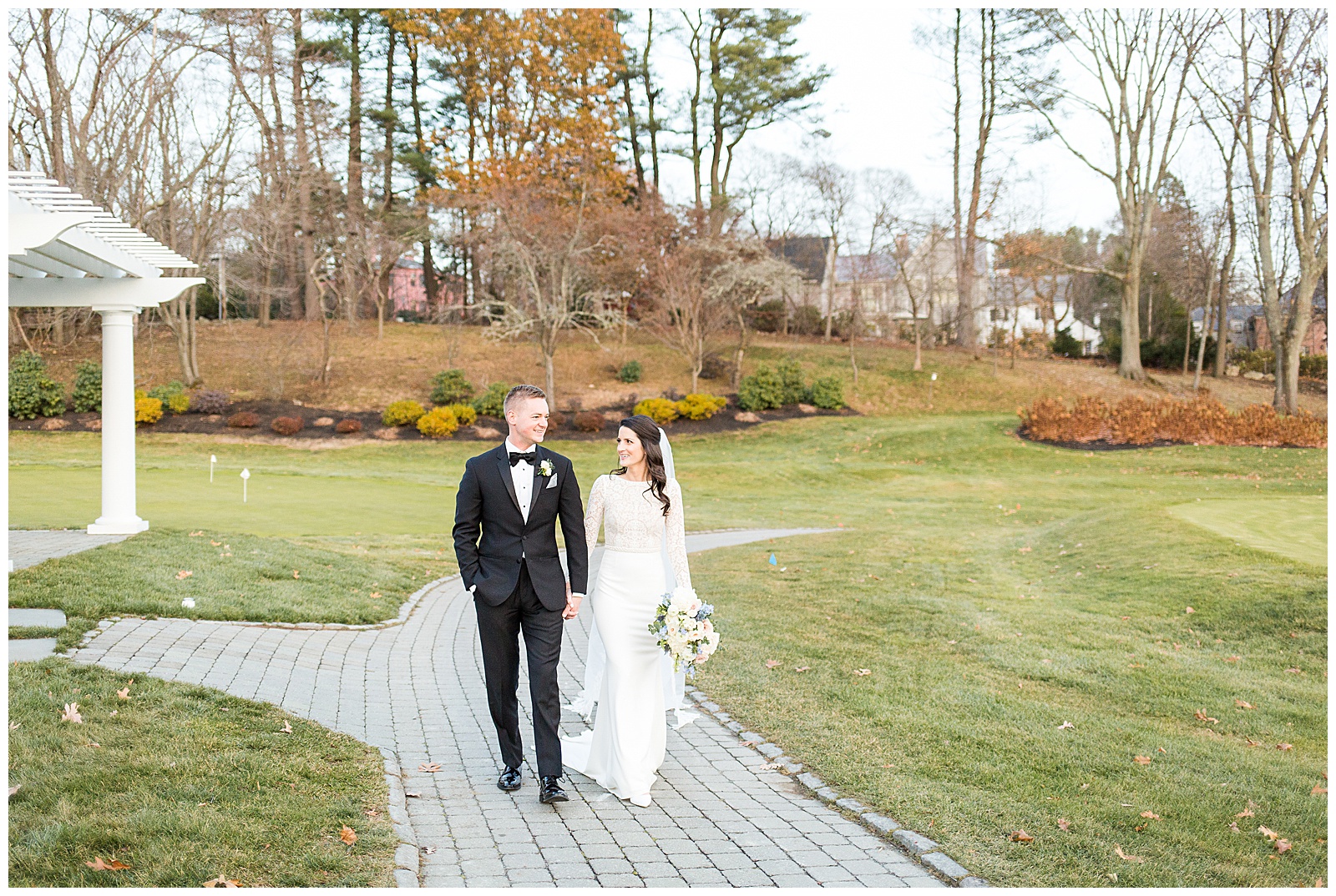 Bride and Groom walk down the path at Brae Burn Country Club