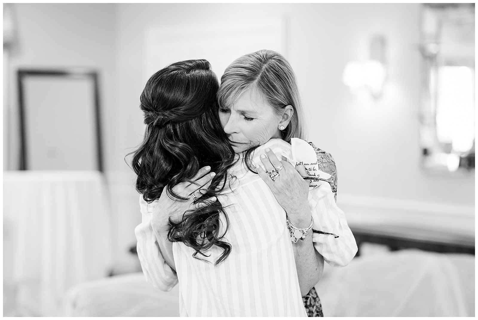 Mother of the bride and bride share a tender moment