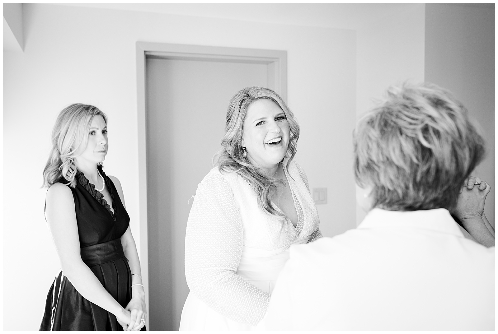 bride laughing while getting ready