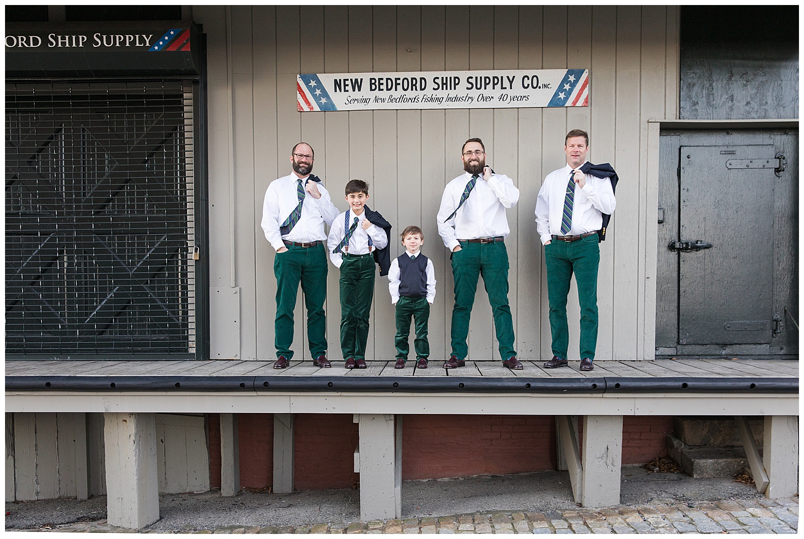 Groomsmen pose on loading dock in New Bedford 