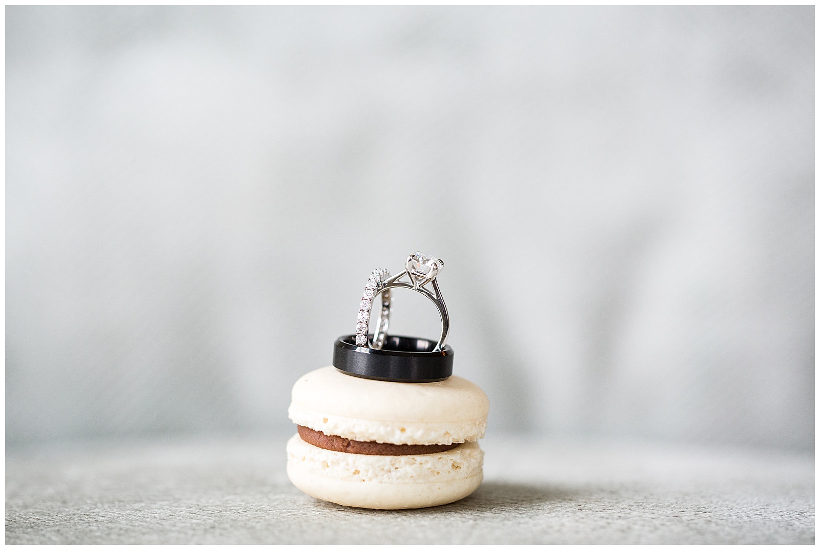 wedding rings sitting on a vanilla and chocolate macaroon