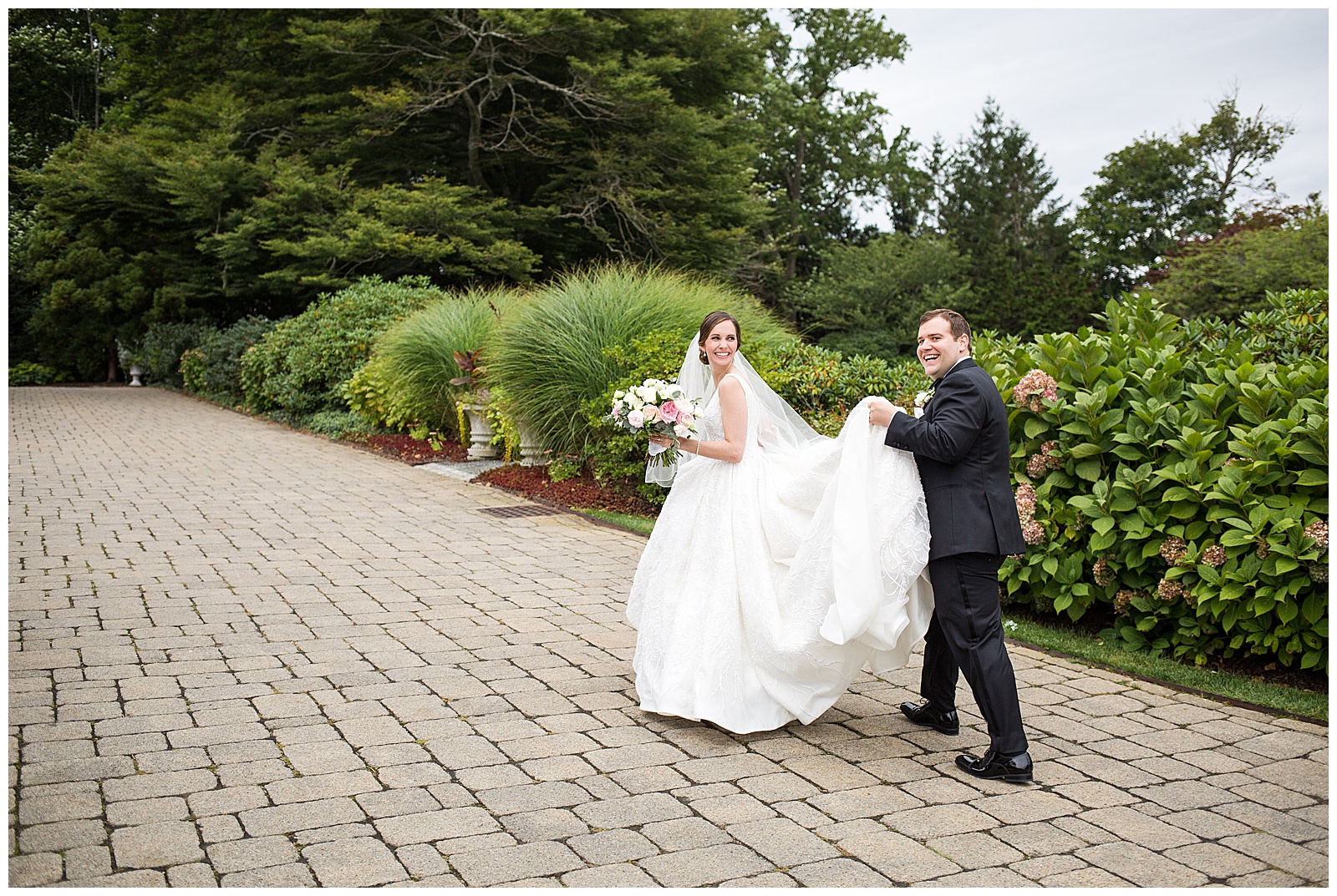 Bride and Groom share a laugh walking up the path at the Chanler