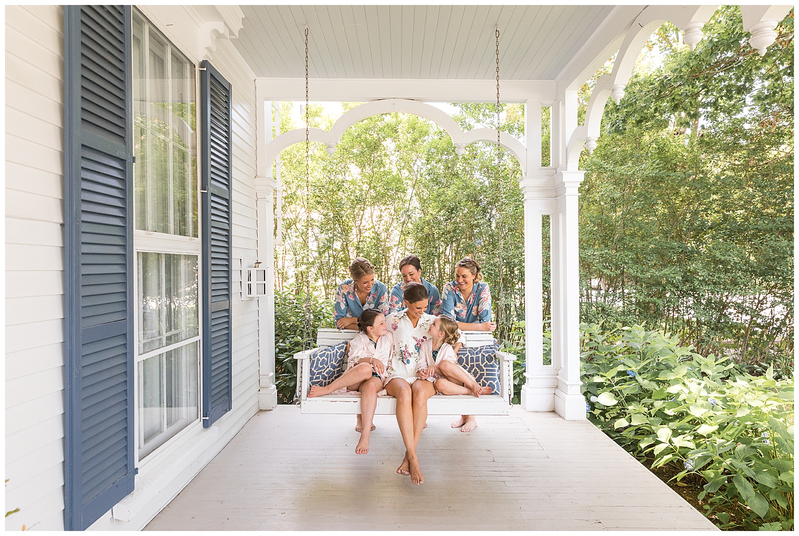 Bridesmaids relax on the front porch swing at the Bayberry Inn