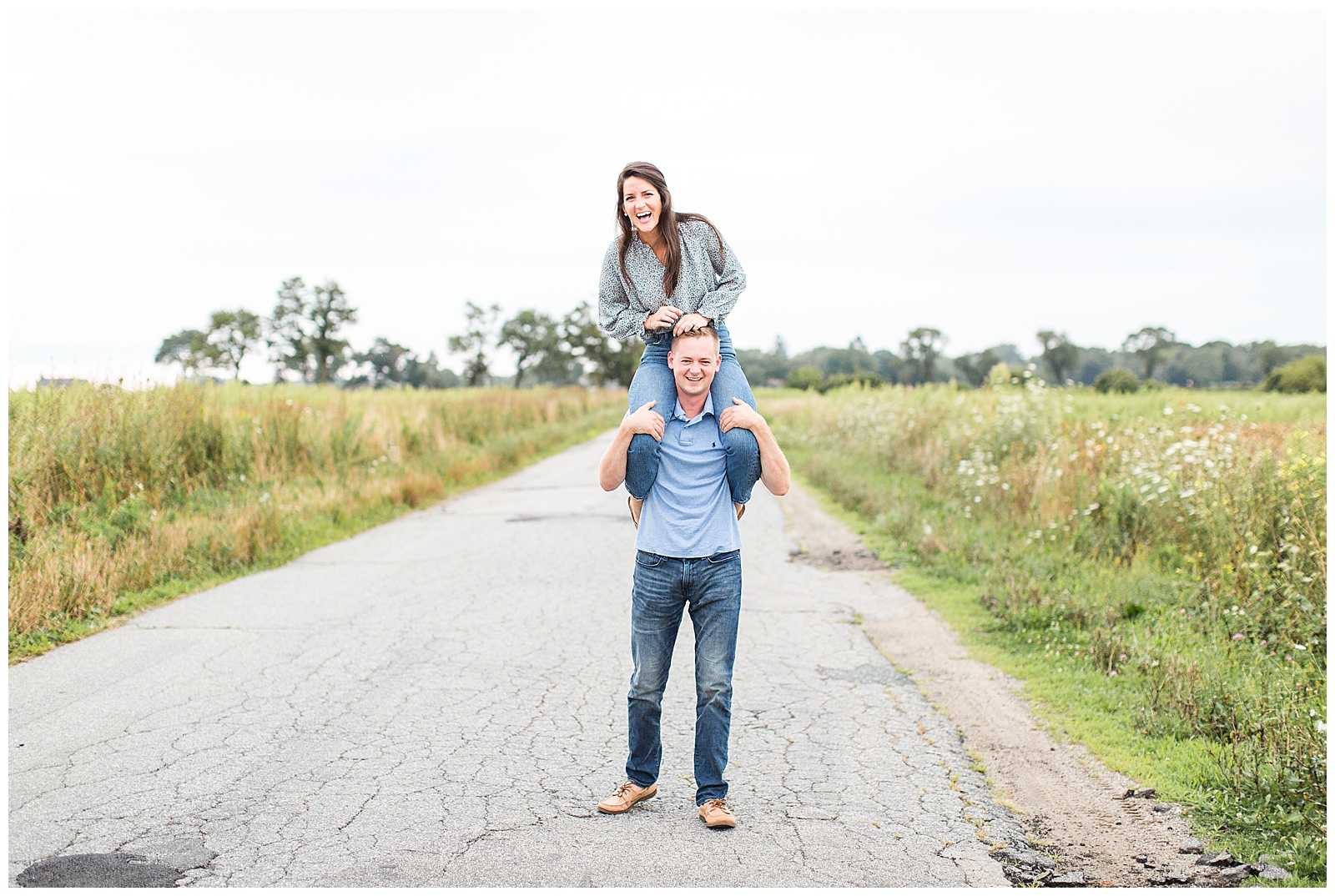 fiance puts his fiance on his shoulders during engagement session