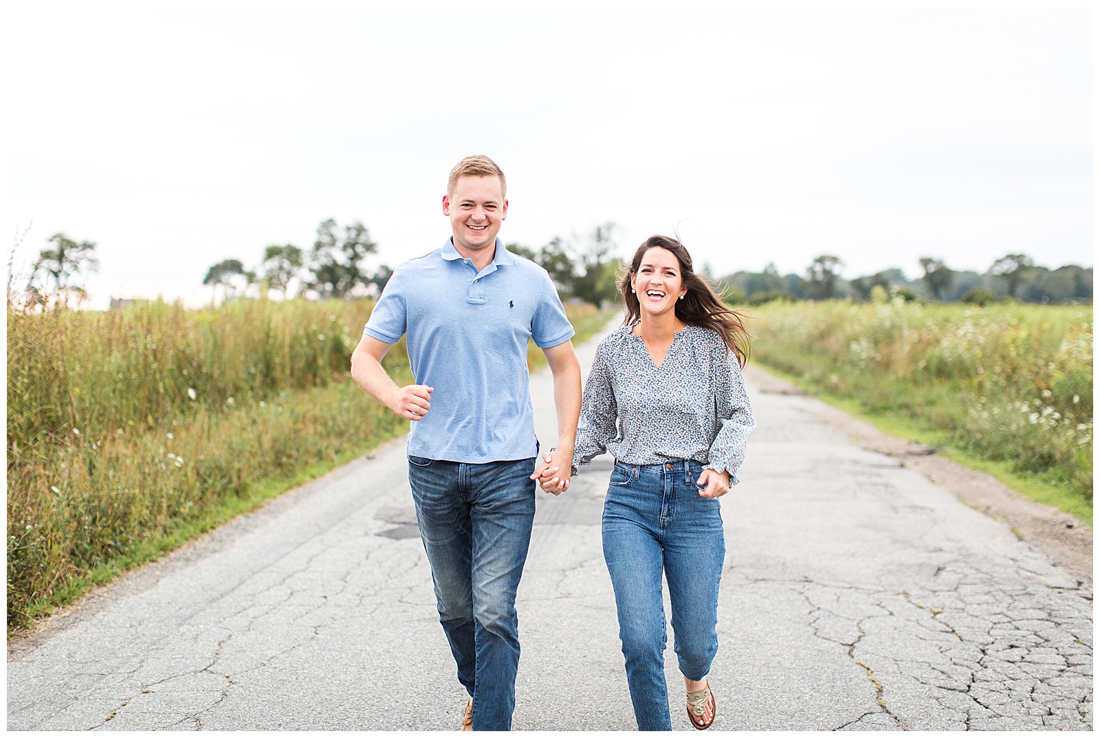 Bride and Groom to be run down dirt road at engagement session