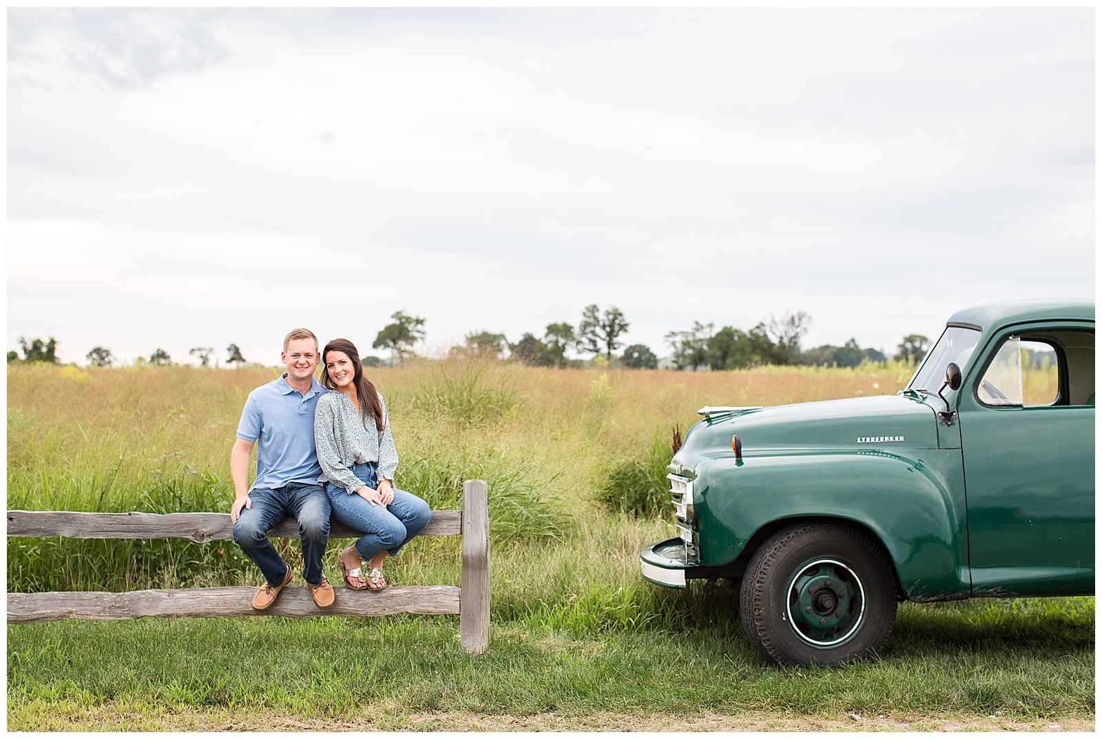 fall engagement photo session in a grassy field with a vintage truck