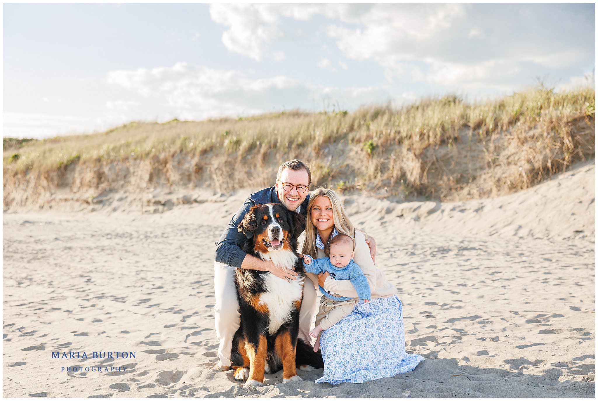 family poses on newport beach with bernese mountain dog