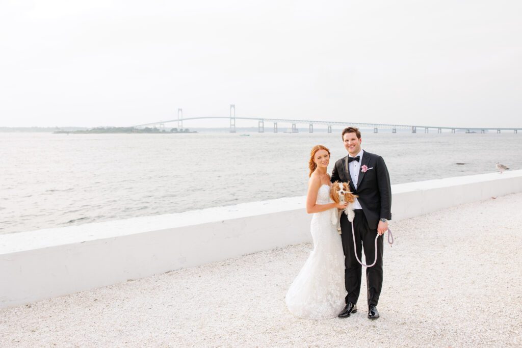 pup outside wedding with bride and groom in newport 